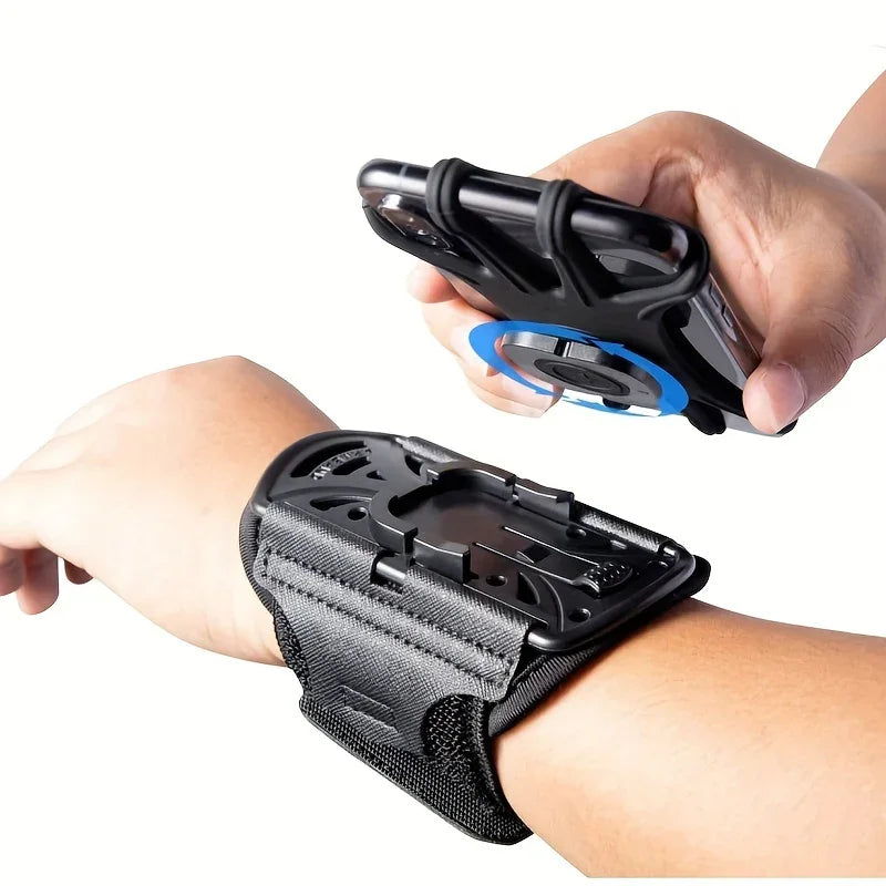 Adjustable black wrist phone holder for smartphones, shown attaching to a person's arm.