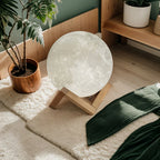 3D moon lamp on wooden stand in cozy bedroom with plants and soft rug