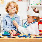 Kids playing doctor with STEM medical toys, girl in costume using stethoscope on boy