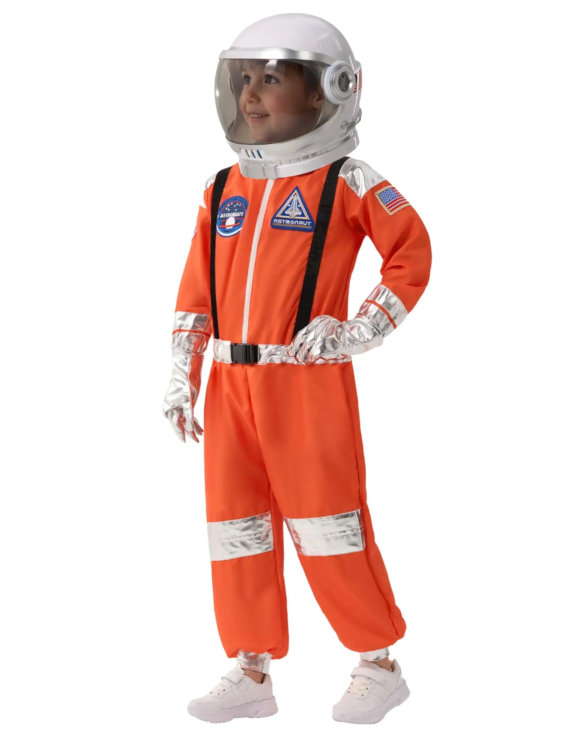 Child wearing orange astronaut costume with helmet and silver accents, standing and smiling