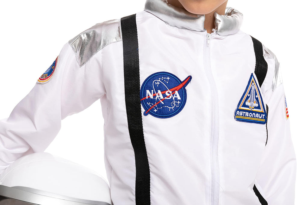 Child in white astronaut costume with NASA and space patches, holding a space helmet.