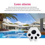 Paw-shaped anti-loss alarm keychain for pets or valuables, shown by a modern house with pool.