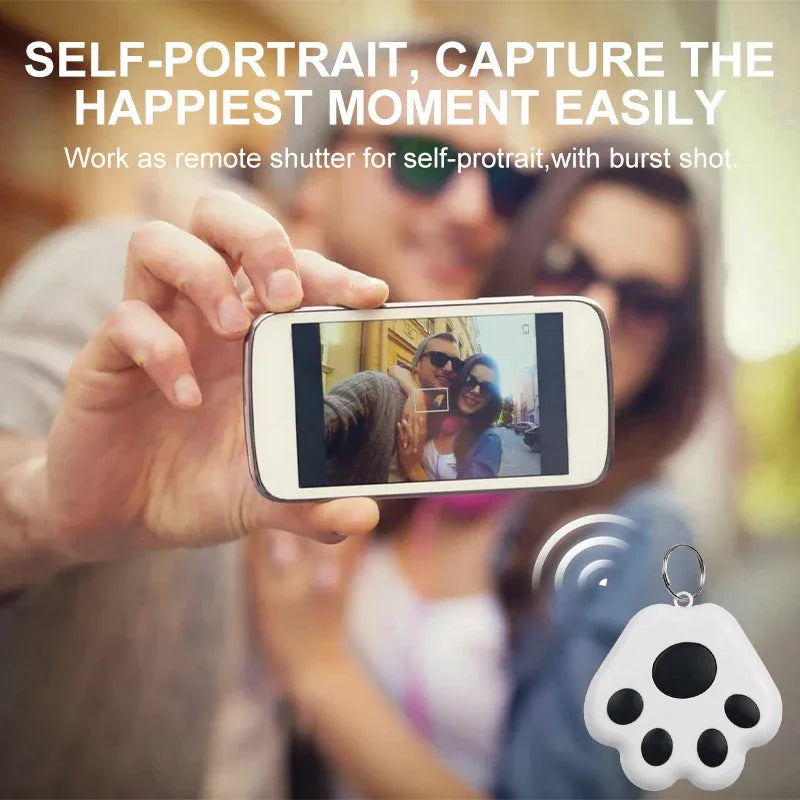Couple taking a selfie with smartphone using paw-shaped remote shutter keychain
