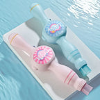 Pastel blue and pink double-ended cleaning brushes with playful 'Lucky' and 'Sweet' labels by a pool.