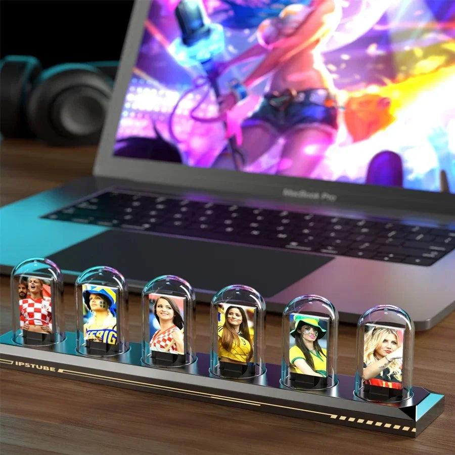 Colorful desktop display with six LED glass capsules featuring fan images, set in front of a laptop with a vibrant screen, perfect for tech and gaming setups.