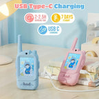 Blue and pink kids walkie talkies with cartoon screens, USB Type-C charging on desk