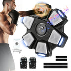 Man uses electronic music boxing machine with gloves, LED targets, and digital display.